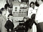 A family poses in a launch control center in the mid-1960s.